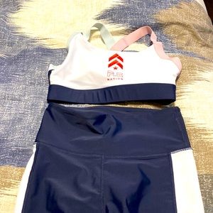 PE Nation set- navy and white sports bra and matching leggings with Barry’s logo
